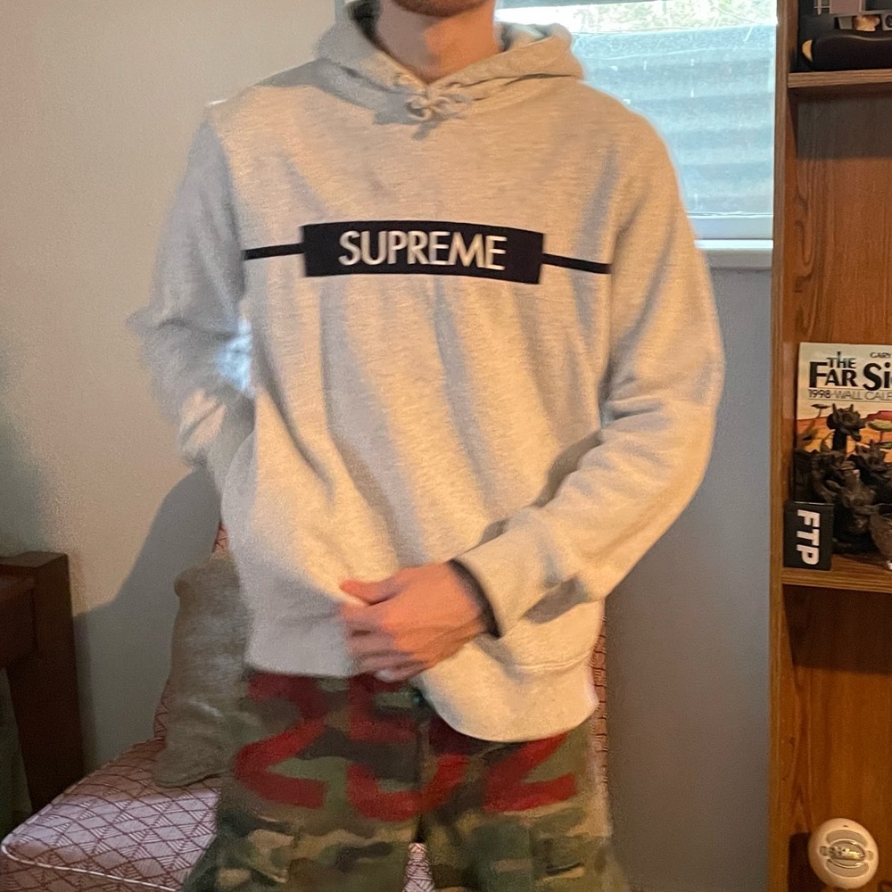 light grey supreme navy box logo hoodie w/ hidden pockets in the side seams.